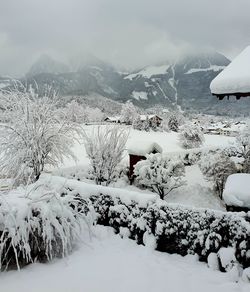 Snow covered landscape against sky