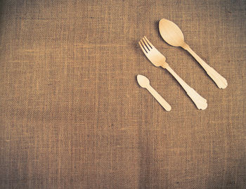 High angle view of forks and spoons on seat