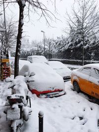 Snow covered car on road