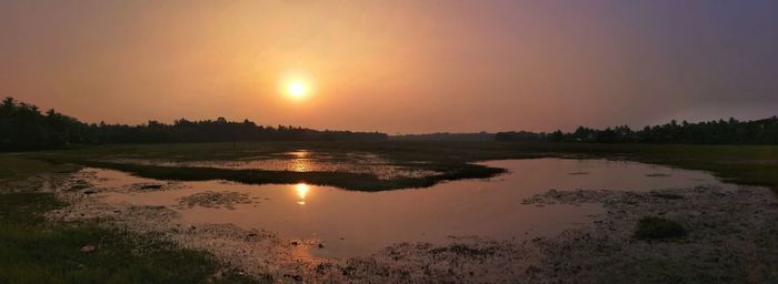 Scenic view of lake against sky during sunset