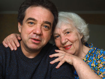 Close-up portrait of mother with son at home