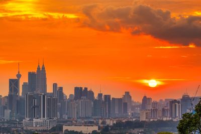 View of buildings against cloudy sky during sunset