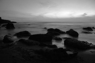 Rocks on beach against sky