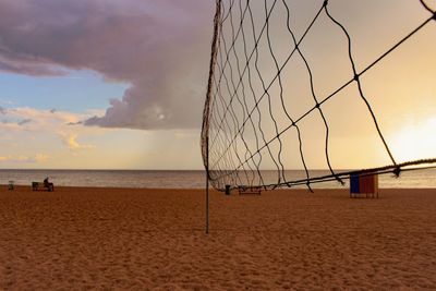 Scenic view of beach against sky during sunset