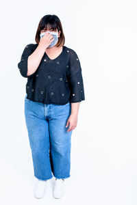 Full length of a beautiful young woman against white background