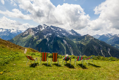 Scenic view of field and mountains against sky