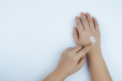 Close-up of woman hand over white background