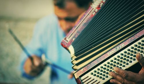 Close-up of man playing guitar