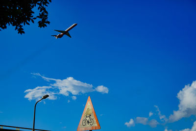 Low angle view of airplane flying in sky