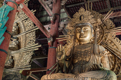 Low angle view of statue against building