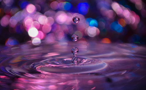 Close-up of drop falling on water