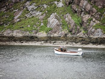 People on river by rock