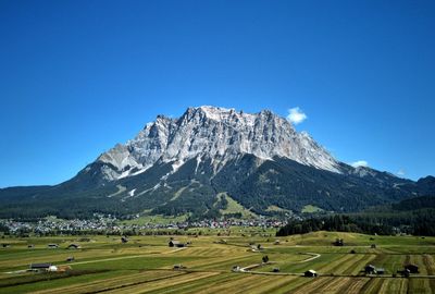 Scenic view of mountains against clear blue sky