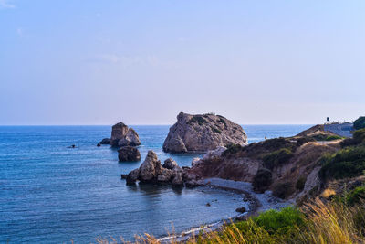 Rocks on sea shore against sky