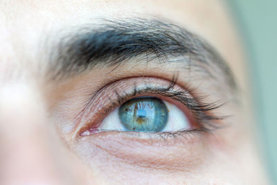 Close up on a blue eye of a man, human eye