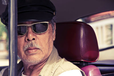 Portrait of man wearing sunglasses in car