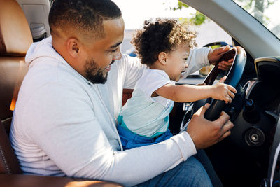 Father and son sitting in car