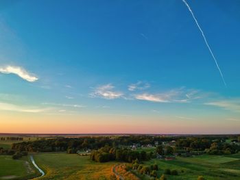 Scenic view of field against sky during sunset