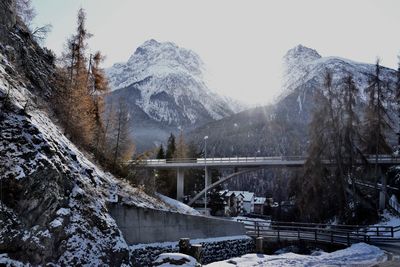 Bridge over river against clear sky during winter