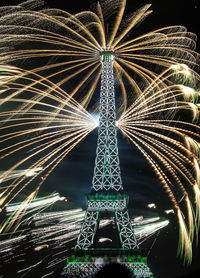 Low angle view of illuminated tower at night