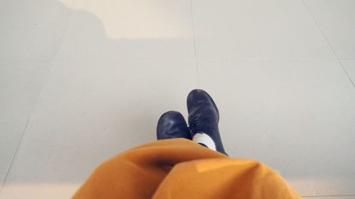 Low section of woman standing on tiled floor