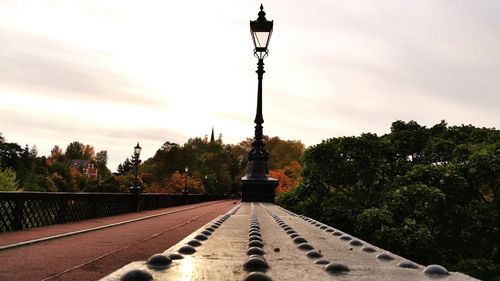 Street light against cloudy sky