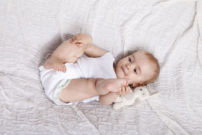 High angle view of baby sleeping on bed