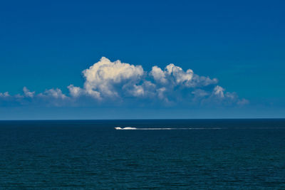 Scenic view of sea against blue sky