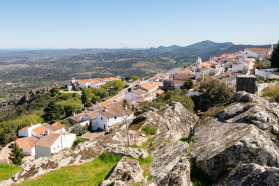 Marvao castle on the top of a mountain with beautiful green landscape behind on summer, in portugal