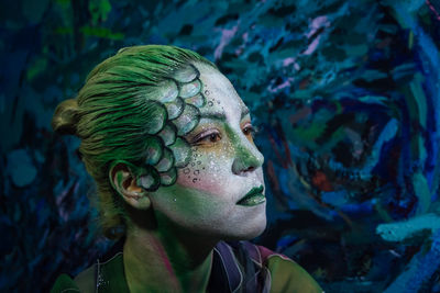 Close-up of thoughtful woman with painted face looking away