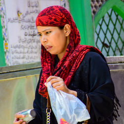 Portrait of young woman looking away outdoors