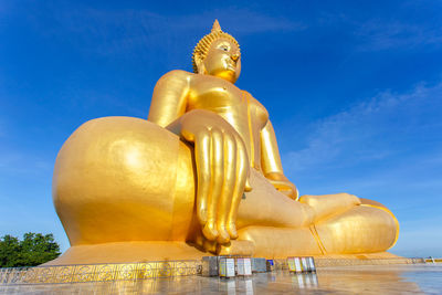 Low angle view of statue against blue sky