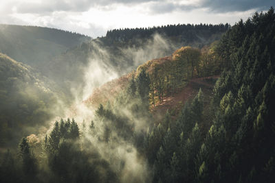 Scenic view of mountains against sky during foggy weather