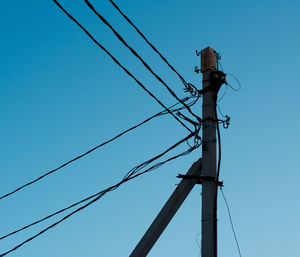 Low angle view of telephone line against clear sky