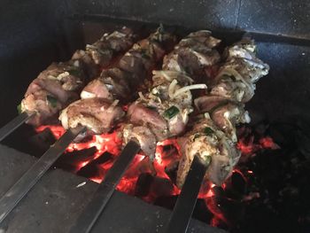 High angle view of meat on barbecue grill