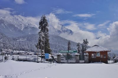 Houses on snowcapped mountain against sky