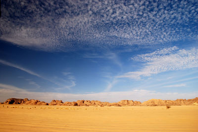Tranquil view of barren landscape against sky