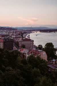 High angle view of townscape by sea against sky