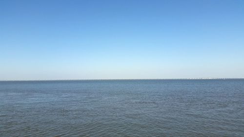 Scenic view of calm sea against clear sky