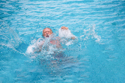 Portrait of man swimming in pool