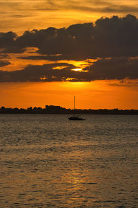 Scenic view of sea against orange sky