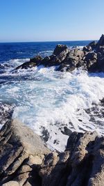 Scenic view of sea against clear blue sky
