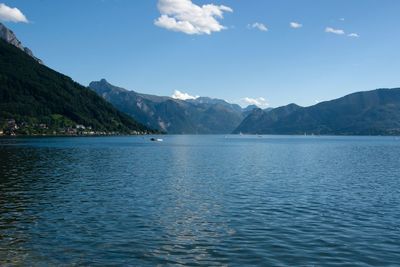 Scenic view of sea and mountains against sky