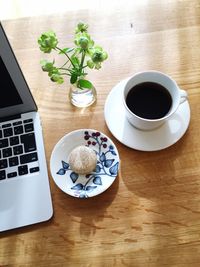 Close-up of cropped laptop and black tea on desk