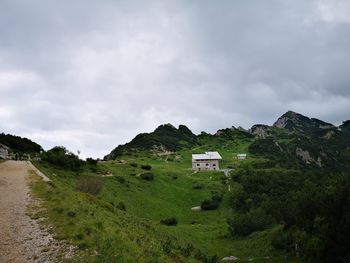 Scenic view of field and mountains against sky