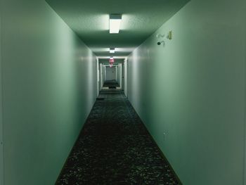 Illuminated empty corridor in building