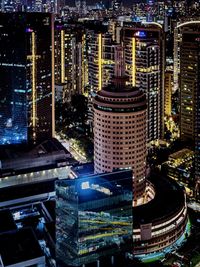 High angle view of illuminated buildings in city at night