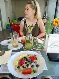 Young woman with drink on table