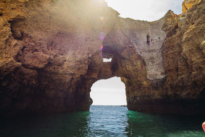 Scenic view of rock formation in sea against sky