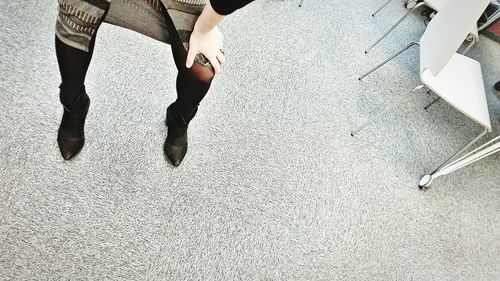 Low section of woman standing on tiled floor